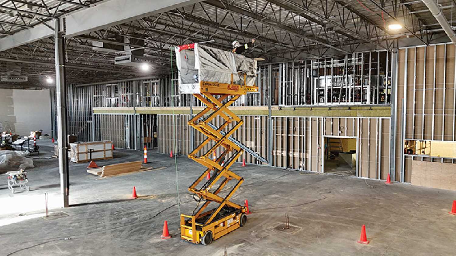 A worker paints the ceiling inside Borderland Co-op’s new 30,000 square foot food store in Moosomin. The $18 million project will be complete next year.